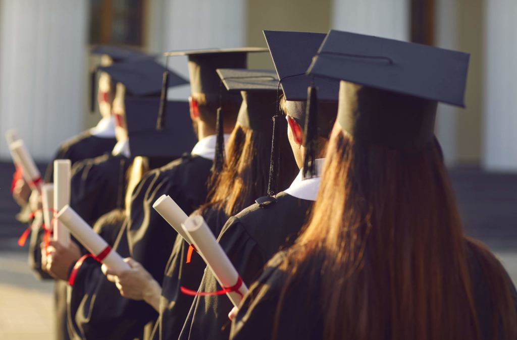 Group of university graduates lined up wearing the cap and gown