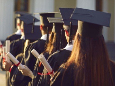 Group of university graduates lined up wearing the cap and gown