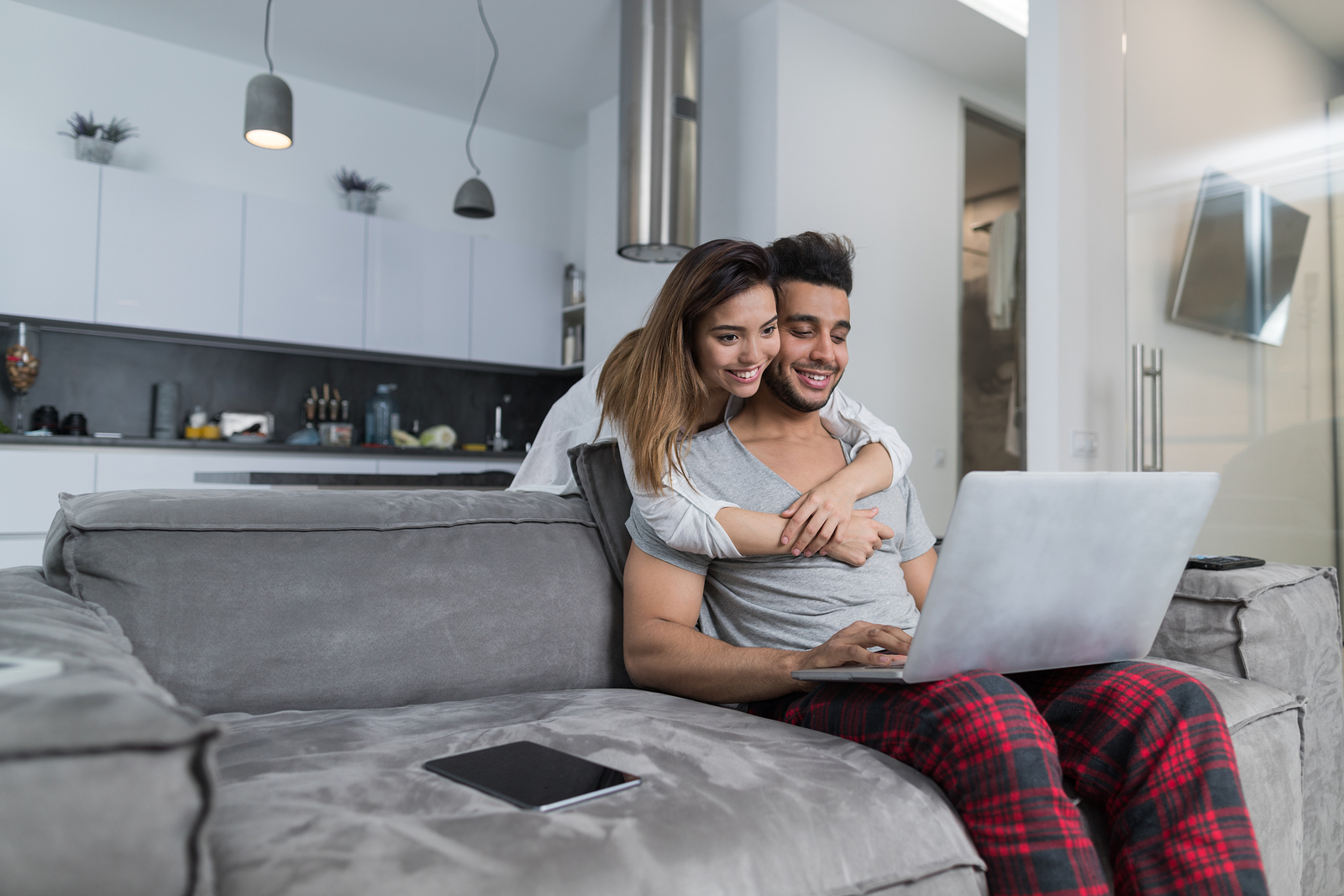 Couple Use Laptop Computer Together In Living Room, 