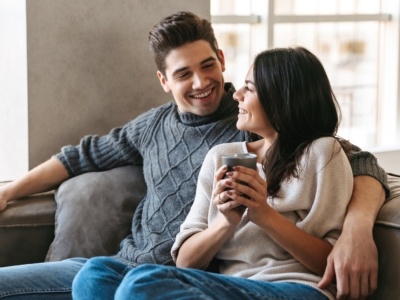 Loving couple cosy on sofa in small house