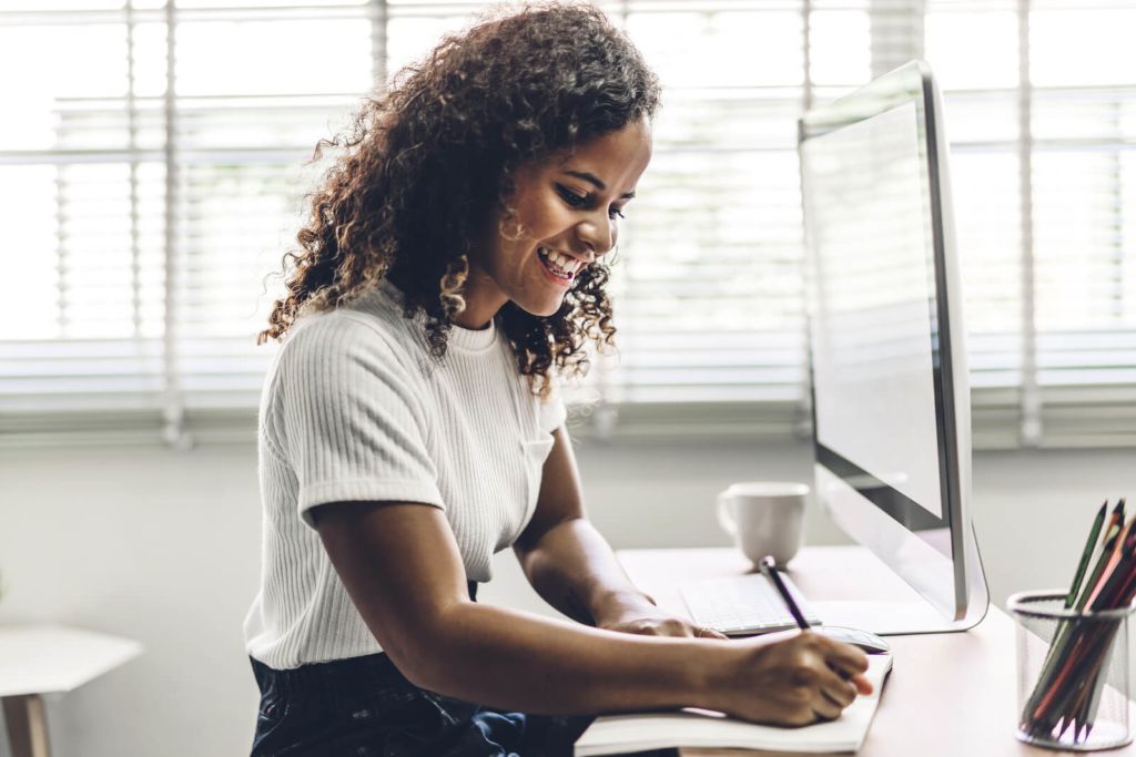 a woman working from home - sat at her desk