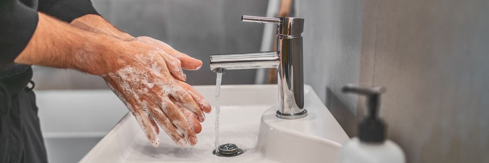 washing hands at sink because of coronavirus