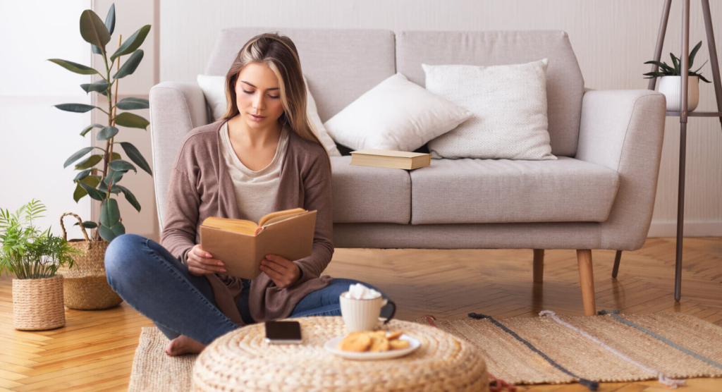 A self-isolating student reading her book