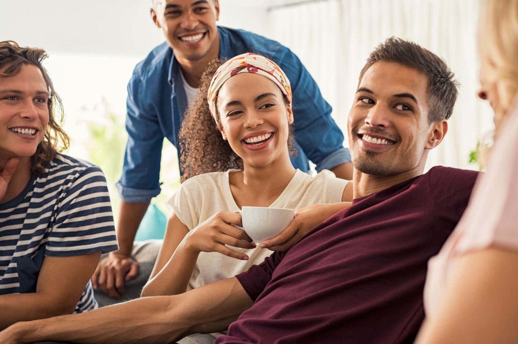 students in a houseshare being friends and drinking tea
