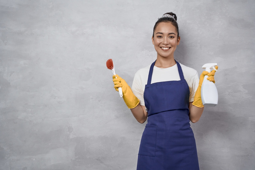 A happy housemate with cleaning products for cleaning the house share
