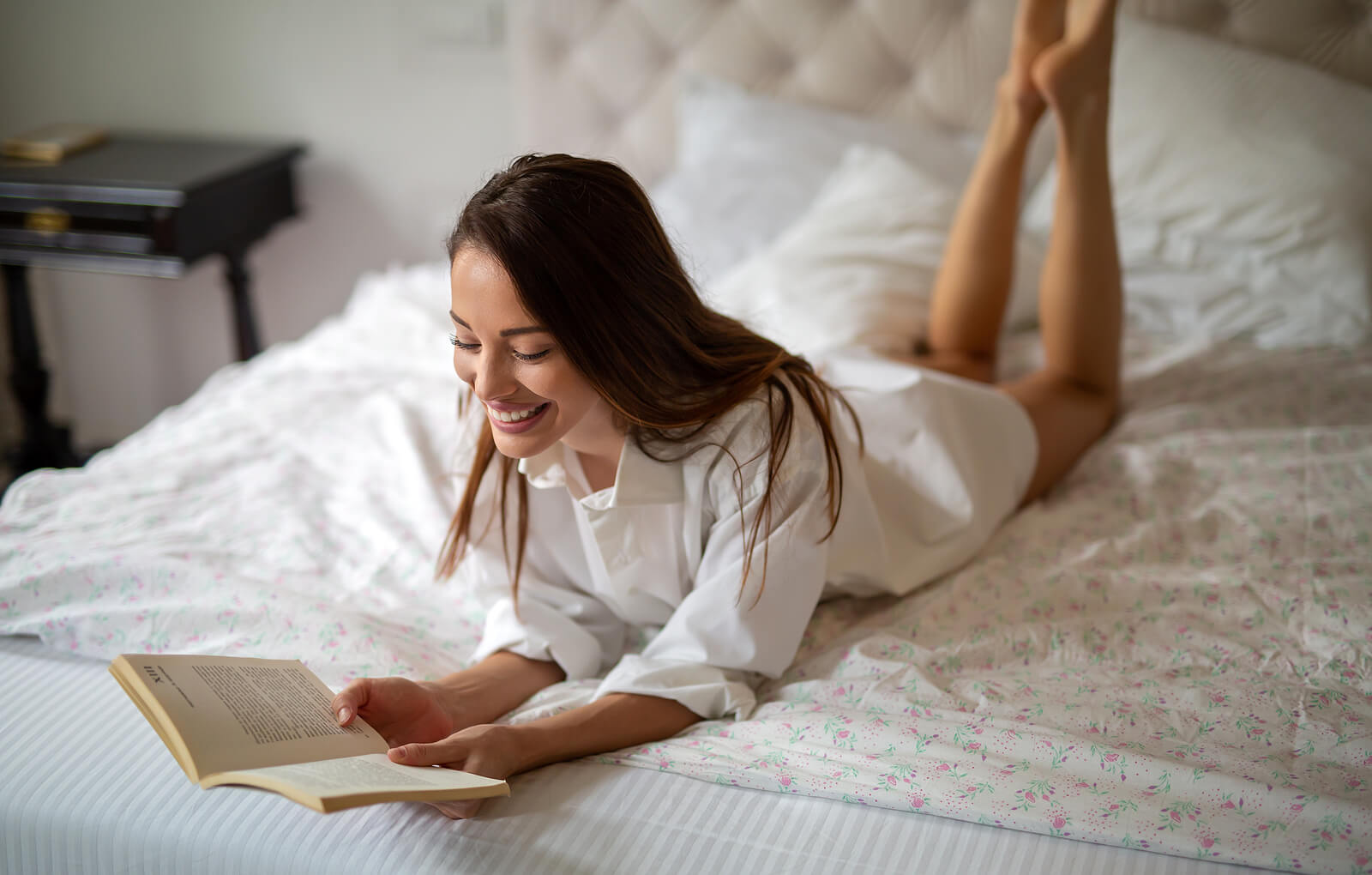 Female introverted housemate reading on bed