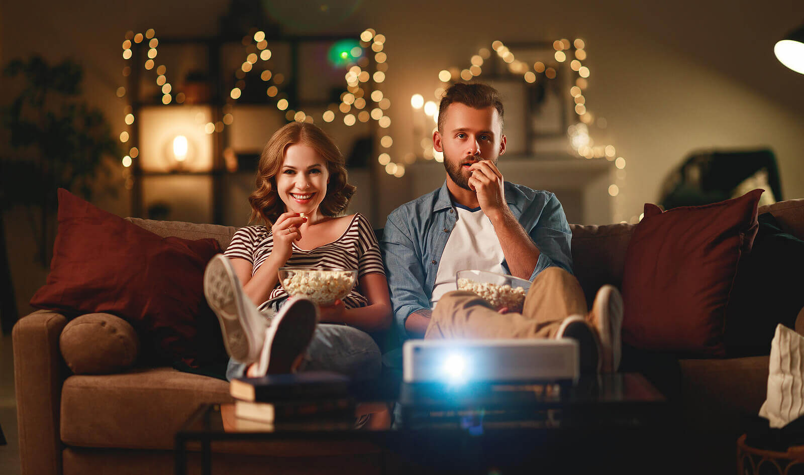 Young couple enjoying a movie night on the sofa on Valentine's Day