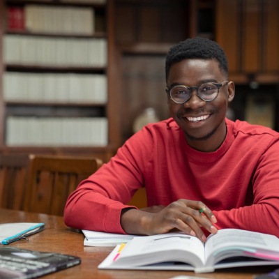 A male university student studying and reading books