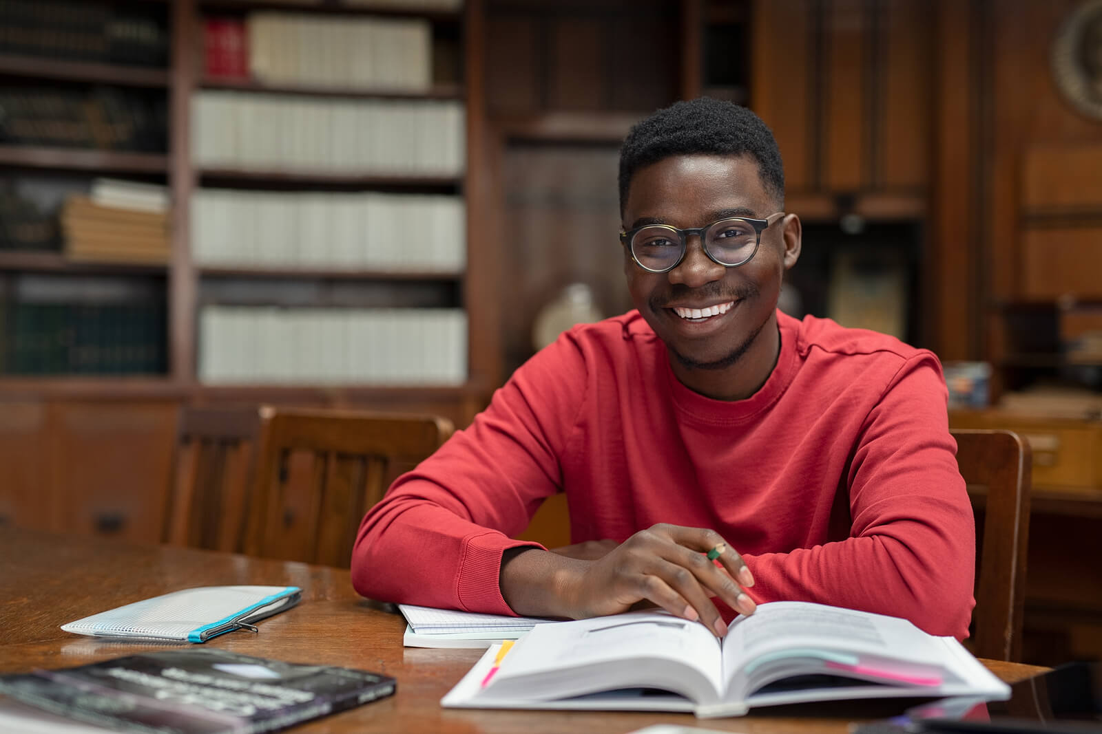 A male university student studying and reading books