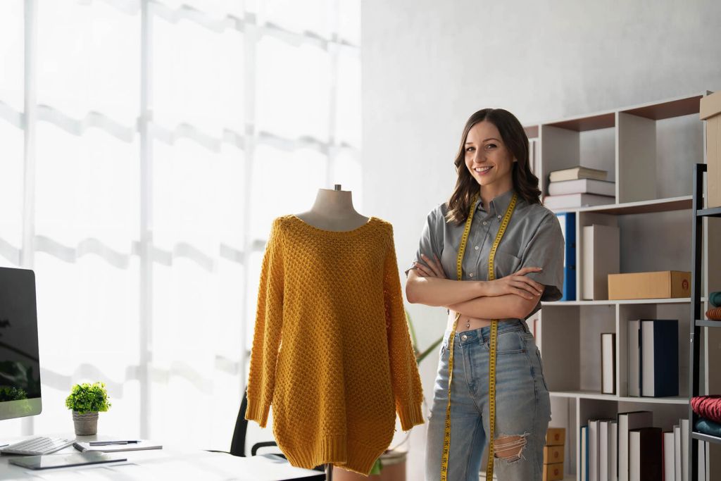 A female fashion designer stood next to her latest creation.