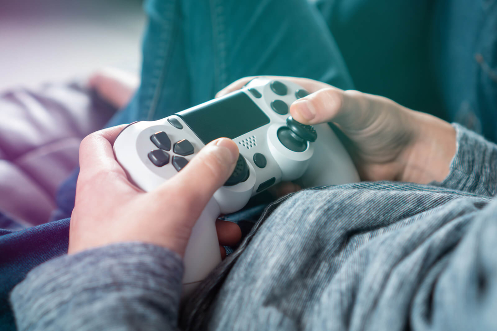 Close-up of a teenager or student's hands using a game controller