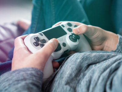Close-up of a teenager or student's hands using a game controller