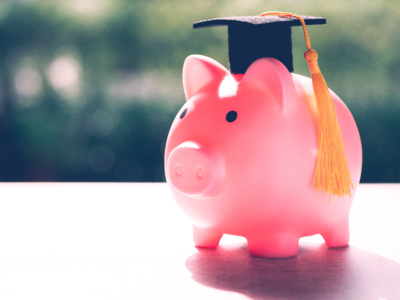 A pink piggy bank wearing a graduation cap, representing the concept of graduate banking.