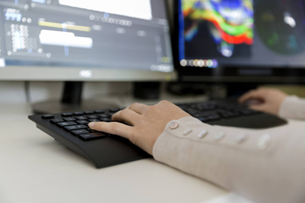 A woman working on a computer, using technology at work.
