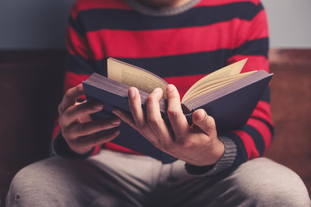 Close-up of man reading a book