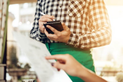Close-up of a waiter taking an order
