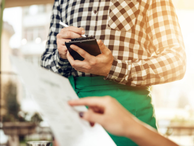 Close-up of a waiter taking an order
