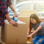 A young couple packing boxes to move house