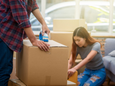A young couple packing boxes to move house