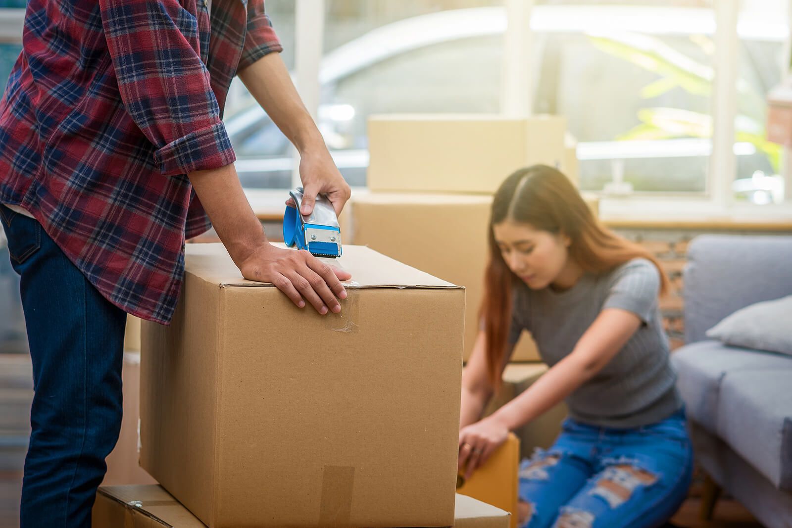 A young couple packing boxes to move house