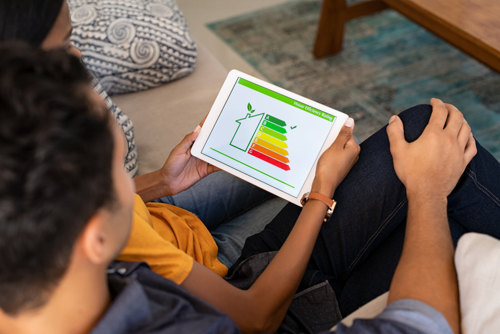 An Indian couple checking the energy efficiency of a new home on a tablet.
